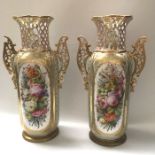 A pair of early 20th century continental twin handled vases, cylindrical and reticulated form,