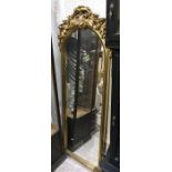 A gilt framed wall mirror with foliage scroll surmount, 181cm high