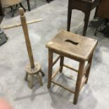 An elm high stool, pierced seat, on block supports united by stretchers 67cm high, together with a