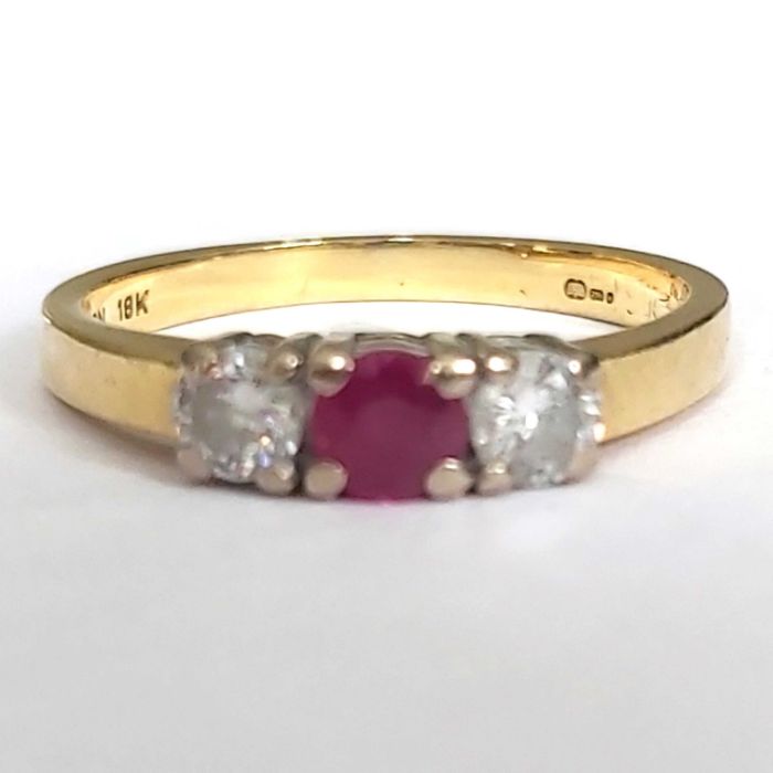 A 18ct gold, ruby and diamond three-stone ring, 2.5g