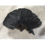 A faux tortoiseshell and black ostrich feather fan