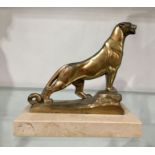 Frecourt, an Art Deco gilt metal figure, modelled as a lion, on marble slab base