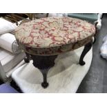 A George II style mahogany and tapestry upholstered stool, oval form, with foliate carved cabriole