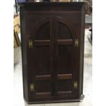 A late 18th Century mahogany corner hanging cupboard, parquetry dentil cornice, canted corners, twin