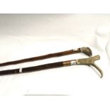 Two walking sticks, one with carved resin handle in the form of a pheasant's head, the other with