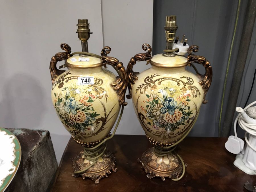A pair of urn form floral painted table lamps, gilt foliate twin handles, 46cm including fitting