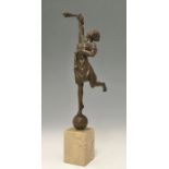 A bronze figure of a torch holder, modelled standing on a ball, block base, 36cm high