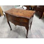 A Dutch marquetry inlaid serpentine lowboy, the top decorated with a twin handled flower filled