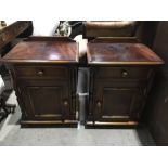A pair of mahogany effect wooden bedside cabinets fitted drawer over single door on bun feet 47cm