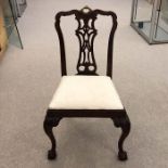 A set of four Chippendale carved dining chairs interlocking scroll lattice splats with clasped
