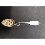 A George III silver fiddle pattern berry spoon, possibly Thomas Watson, gilt bowl with engraved