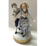 A Capodimonte figure group, Blind Man's Buff, modelled as an 18th century lady with blindfold and
