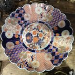 A large Japanese Imari charger painted with geometric radiating panels and chrysanthemum motifs,