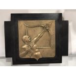 An Art Deco gilt bronze plaque of an archer, modelled in relief, on ebonised wood backing, 23cm