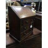 A Victorian mahogany apprentice bureau, fall front over three graduated drawers, 41cm high