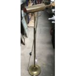 A pair of brass reading standard lamps, and a three tier pot stand (3)