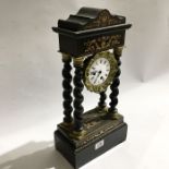 An ebonised and marquetry inlaid portico mantel clock, with twist carved columns on stepped block