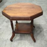 An aesthetic style oak octagonal two tier occasional table, carved receded baluster supports on