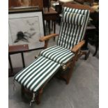 A teak Tiger Trading steamer chair, with pinstripe cushioned seat pad