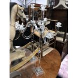 A pair of Adelia crystal candelabra, four branch, five light on facet cut column supports and