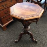A VICTORIAN ROSEWWOD PEDESTAL SEWING TABLE, CIRCA 1850, the octagonal lid inlaid with foliage scroll