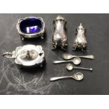 A matched George V four piece silver and EPNS cruet set, various dates and maker's marks, on four