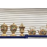 A collection of fruit painted Baroness china vessels including a pair of large lidded urn vases