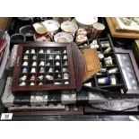 A large collection of thimbles and display cases,