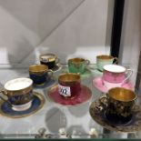 Eight Royal Worcester cabinet coffee cups and saucers including raised gilt and jewelled examples