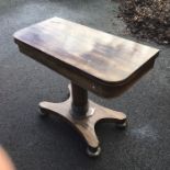 A William IV rosewood pedestal tea table, the column base on quatrefoil platform and bun feet,