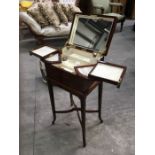 A mahogany ladies vanity chest on stand, mirror lined lift up lid, fitted interior with swing out