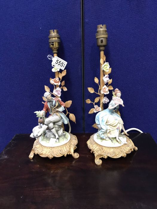 A pair of Capodimonte and gilt metal figural table lamps modelled as 18th century courting couple (