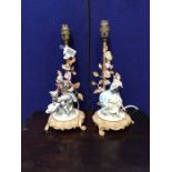 A pair of Capodimonte and gilt metal figural table lamps modelled as 18th century courting couple (