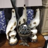 Three large ceramic bird figures, modelled on baluster plinths, together with an enamelled and metal