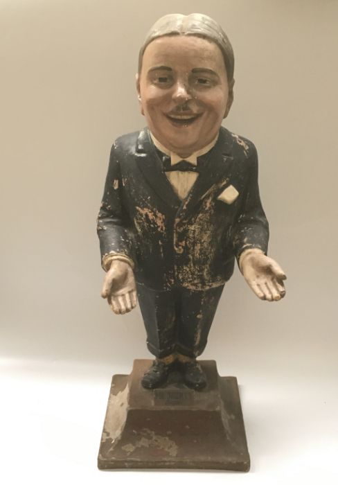 An early 20th century papier mache advertising figure 'Mr Jaunty says Hair Cut Sir', 72cm high