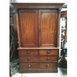 A mahogany linen press, cockbeaded doors revealing three tray interior, above three graduated