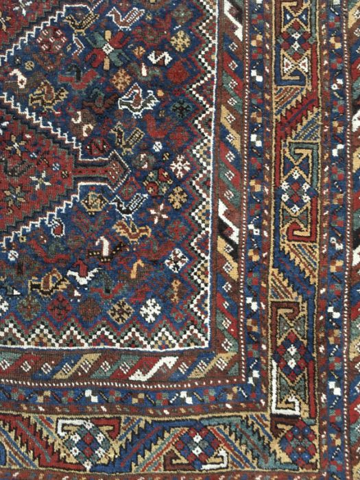 A Caucasian woven wool carpet, geometric lozenge design within field of stylised birds and geometric - Image 2 of 2