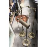 Two brass standard reading lights, one fitted circular tray (3)
