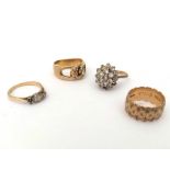 Four gold rings, including a 9ct gold diamond cluster ring (two diamonds missing), a three-stone