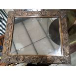A carved oak framed wall mirror, and an oval gilt framed mirror. (2)
