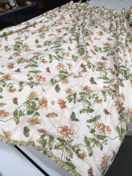 A pair of professionally made glazed cotton curtains, decorated with honeysuckle and butterflies,