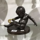 A bronzed and gilt sculpture, modelled as Cupid re