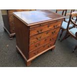 A George III mahogany chest of four graduated cockbeaded drawers, of small proportions, with