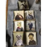 Seven small needlepoint cushions depicting anthropomorphic dog portraits, within mock frame borders,