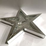 A Julien Macdonald encapsulated crystal mirrored star shape wall clock
