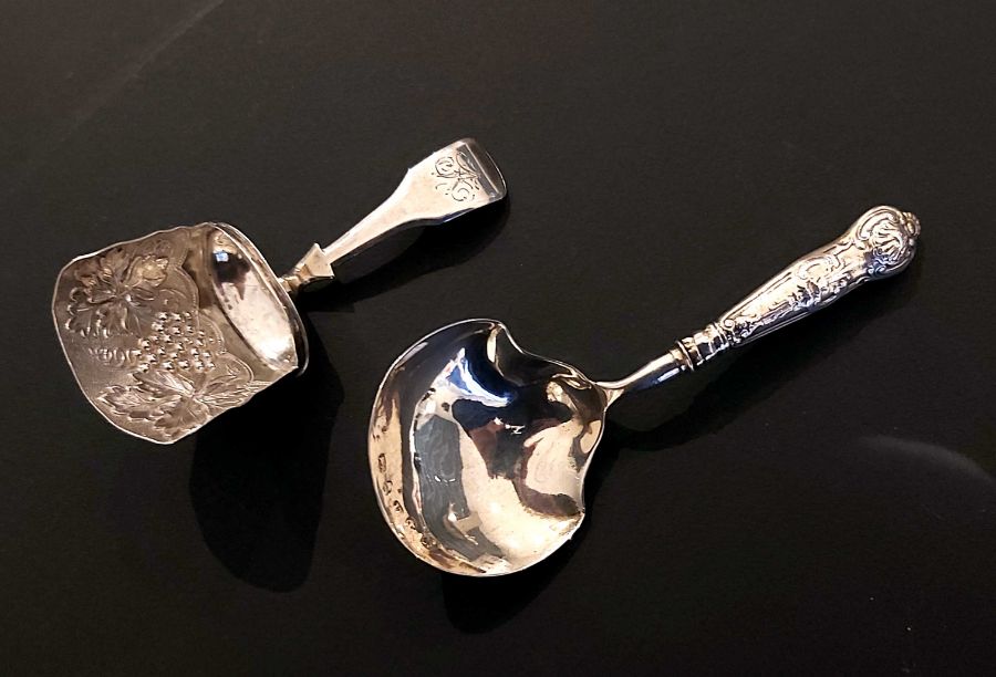 Two Georgian silver tea caddy spoons, one by William Lea & Co, Birmingham 1814, bowl embossed with