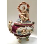 A large Capodimonte relief moulded tureen and cover, modelled with figures, 42cm long
