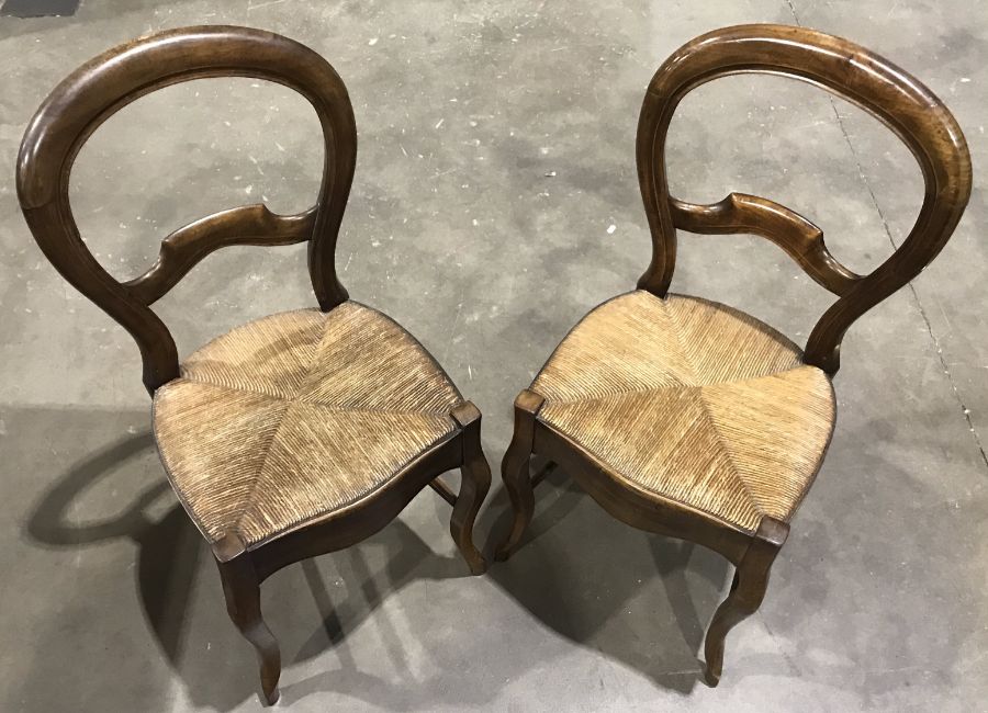 A pair of 19th Century balloon back dining chairs, woven cane seats with serpentine front rails,