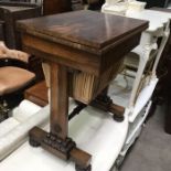 A William IV rosewood work table, swivel fold over top, over drawer and pleated satin pull out well,