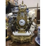 An Imperial Italian gilt metal mantel clock, lyre form flanked by cherubs, on white marble base